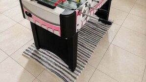 A foosball table in a room with a staircase and a window. - Beach Street Bungalow (Vincentia)