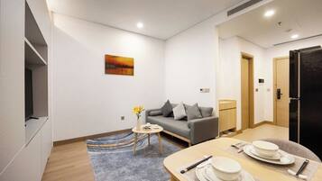Departamento, 1 cama Queen size, baño privado, vista a la ciudad | Área de sala de estar