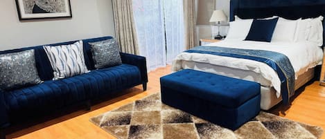 Un dormitorio con cama, sofá y alfombra.