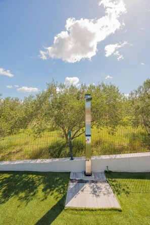 A metal structure with a digital display, set against a backdrop of a grassy field and trees, with a clear sky above. - Holiday Home Bonato with pool by Interhome (Krneza)