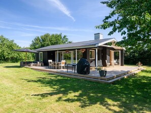 A modern house with a covered patio, outdoor seating, and a barbecue grill. - "Antonie" - 350m from the sea by Interhome (Vejby)