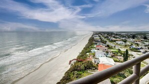 Zona residencial costera con playa, casas y cielo despejado.