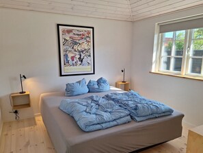 A bedroom with a bed, a window, a framed picture on the wall, and bedside lamps. - "Ethil" - 600m from the sea by Interhome (Gilleleje)