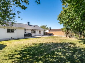 A residential property with a white house, a barbecue area, and a well-maintained lawn. - "Eeske" - 4km from the sea by Interhome (Thisted)