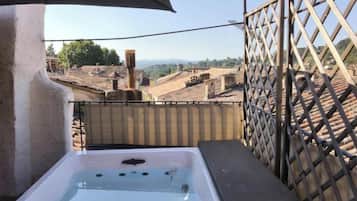 A hot tub with a clear view of a terraced landscape.