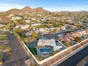 An aerial view of a residential area with houses, a swimming pool, and a basketball court. - Lux Resort - Pool, Pickleball, Hot Tub, and more! (Phoenix)