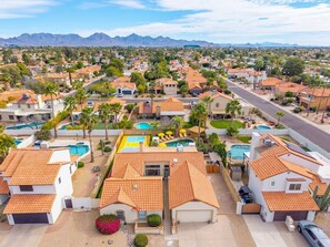 A residential area with houses, a swimming pool, and mountains in the background. - Heated Pool, Spa, Sauna, Mini Golf, Pickleball (Scottsdale)