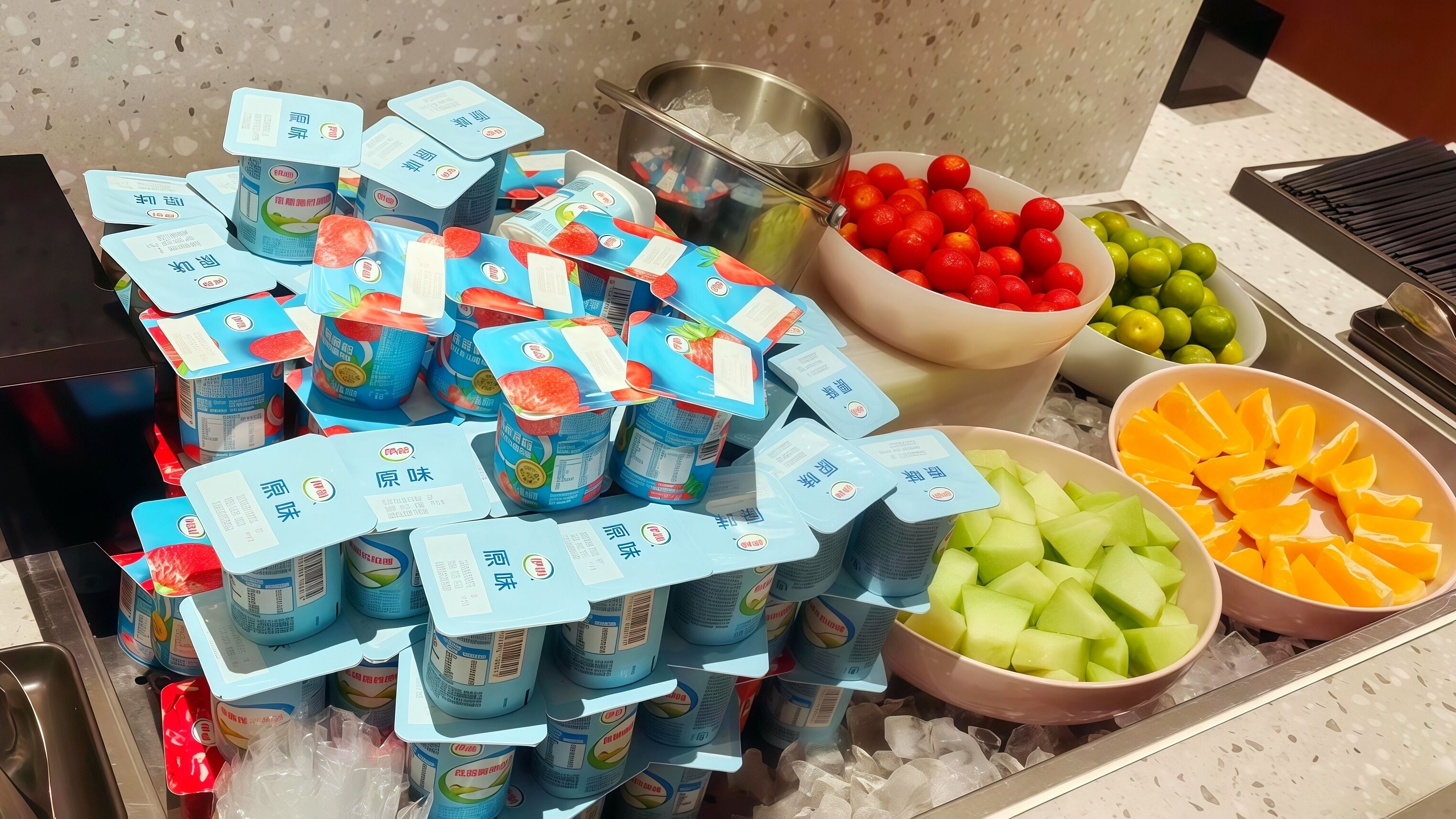 A display of packaged beverages and fresh fruits on a counter.