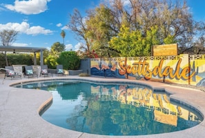 A swimming pool with a mural, lounge chairs, and a pergola. - Ultimate Backyard | Pool, Pickleball, and Golf! (Scottsdale)
