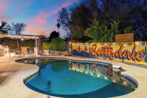 A swimming pool with a mural, outdoor seating, and a covered area. - Ultimate Backyard | Pool, Pickleball, and Golf! (Scottsdale)