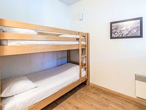 A bunk bed room with a framed picture on the wall and a radiator. - Les Chalets d'Ax by Interhome (Ax-Les-Thermes)