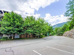 A parking lot with trees and a mountain in the background. - Les Chalets d'Ax by Interhome (Ax-Les-Thermes)