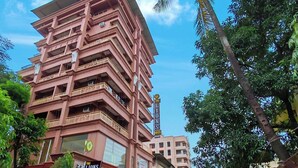 A multi-story hotel with balconies and a sign indicating it is The Lions Hotel.