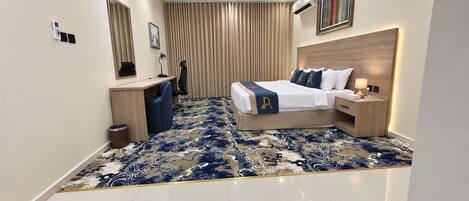 A modern hotel room with a bed, bedside tables, a desk, and a chair.