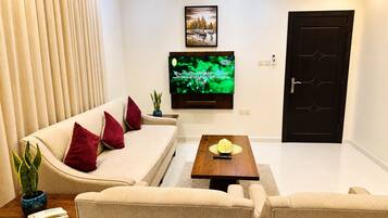Apartment, 3 Bedrooms | Living area | 50-inch Smart TV with satellite channels, streaming services
