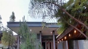 A building with a covered patio area, a small tree, and a well-maintained garden. - Cozzy Darmaga Palayangan Pangalengan (pangalengan)