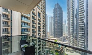 A high-rise building with multiple balconies, large windows, and a view of other tall buildings. - Madely | Opulent Condo Act Two | Burj Khalifa (Dubai)