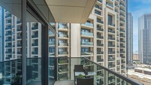 A high-rise building with multiple balconies, large windows, and a modern architectural design. - Madely | Opulent Condo Act Two | Burj Khalifa (Dubai)