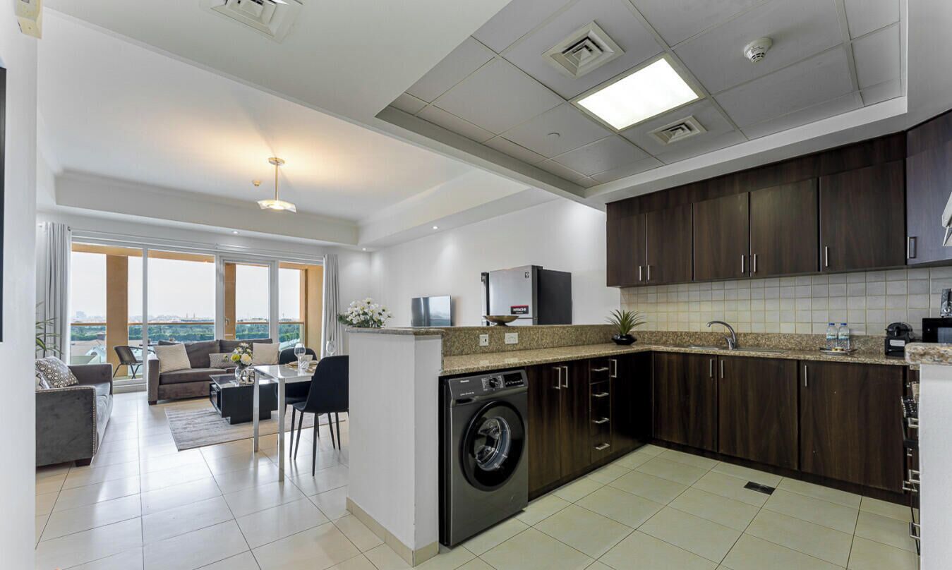 A modern apartment with a kitchen, living area, and a view of the city.