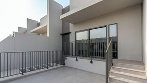 A modern building with a staircase leading to a balcony with a metal railing. - Spacious | 4 Bed Villa | Private Pool | Meydan (Dubai)