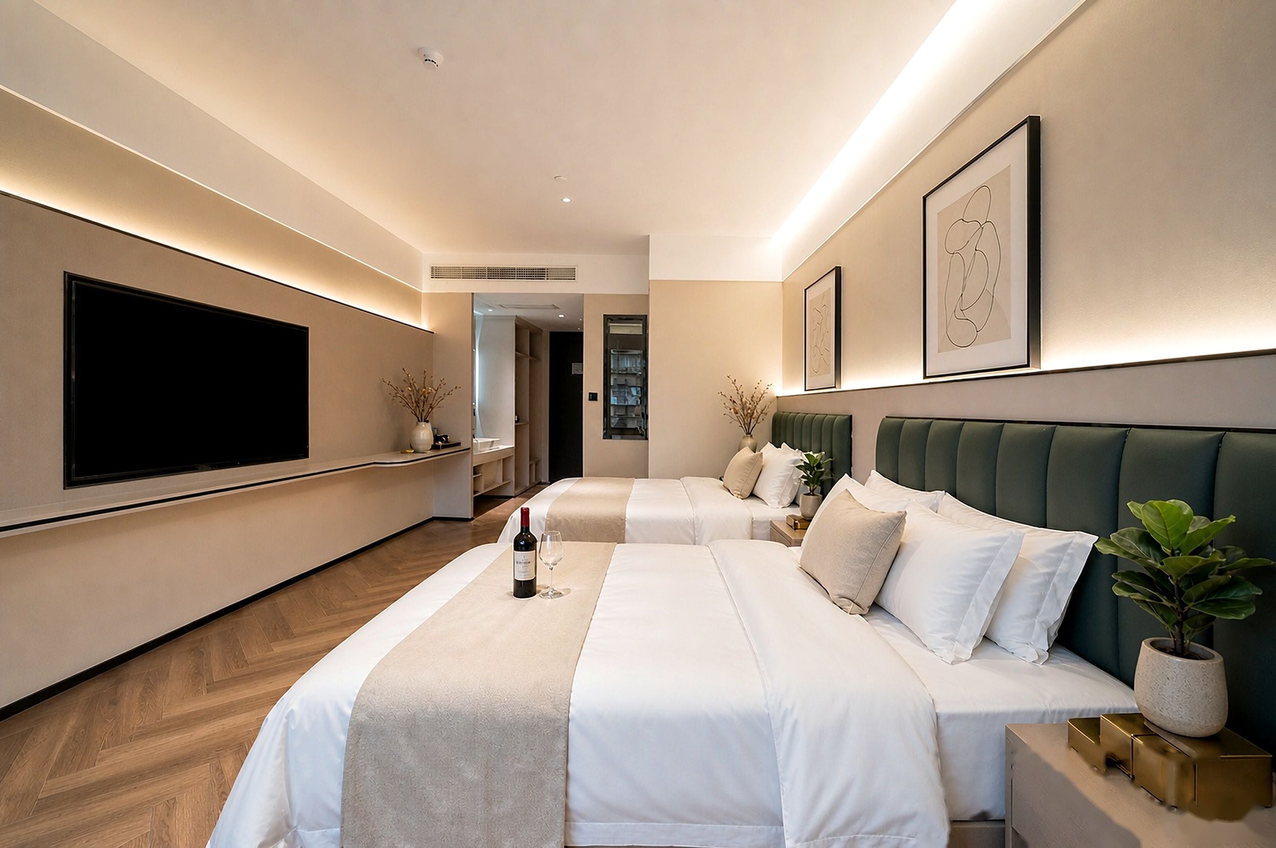 A hotel room with two beds, a flat-screen TV, and a minibar.
