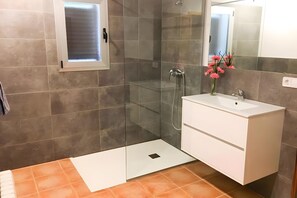 A modern bathroom with a glass shower enclosure, a white vanity, and a small window. - Villa Provenza with Private Pool, Terrace, A/C & Wi-Fi (Las Palmeras)