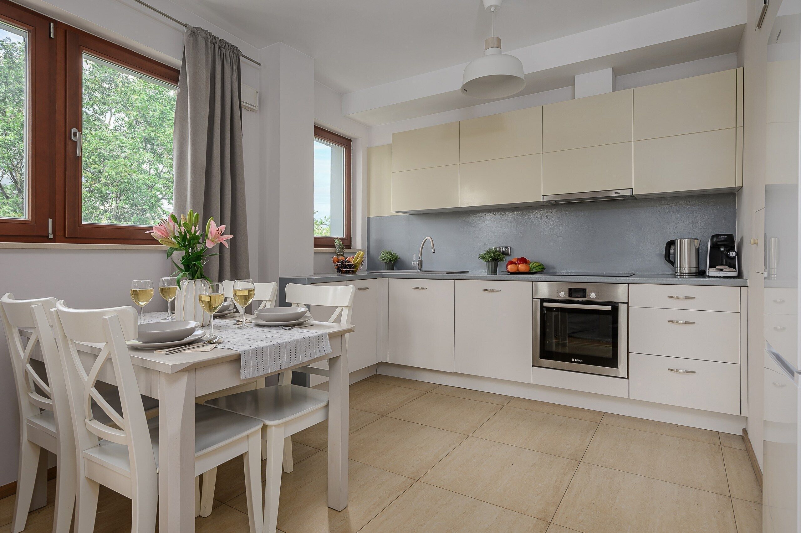 Deluxe Apartment, 2 Bedrooms, Courtyard View | Private kitchen | Electric kettle, highchair, griddle, eco-friendly cleaning products