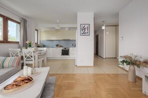 A modern apartment with a dining area, kitchen, and living space. - Lumina 3-room Apart with Parking  (Warszawa)