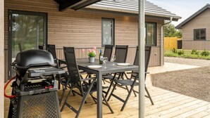 An outdoor patio with a grill, dining table, and chairs. - "Merita" - 600m from the sea by Interhome (Thisted)