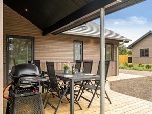 An outdoor patio with a grill, dining table, and chairs. - "Merita" - 600m from the sea by Interhome (Thisted)