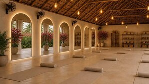 A spacious room with a high ceiling, arched doorways, and a series of shelves with pottery. - White House social club  (Paje)