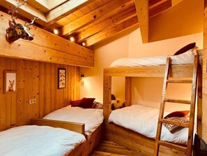 A wooden cabin with bunk beds, a ladder, and wall-mounted decorations. - Ciméro Duplex Chalet—Luxury, Spa, Accommodates 10 Guests (Formiguères)