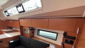 Un intérieur compact comprenant un canapé, une petite table et une fenêtre.