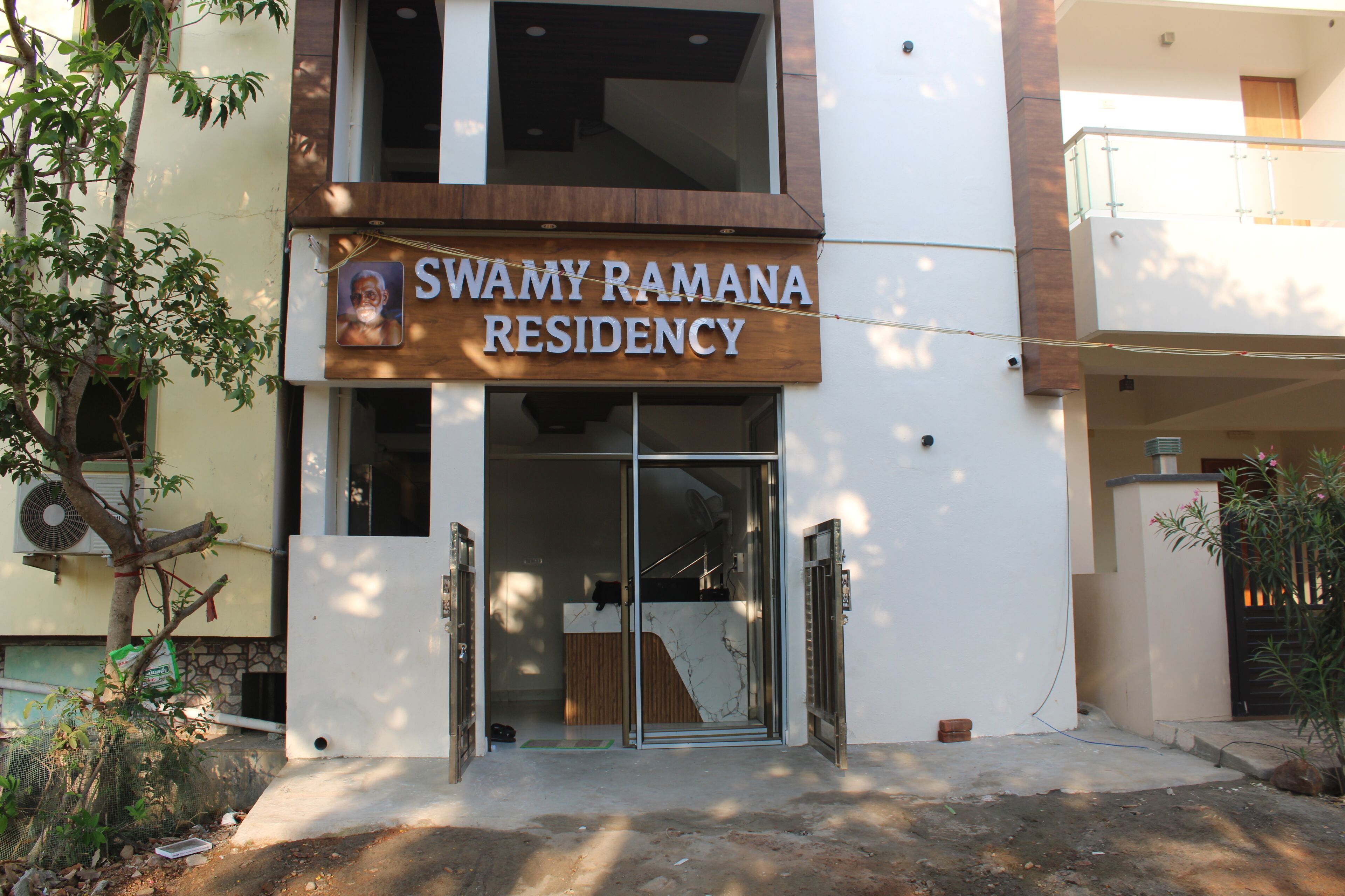 A residential building with a sign reading 'Swamy Ramana Residency.'