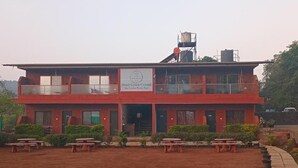 A two-story building with a sign reading 'Hotel Green Crystal.' - Hotel green crystal (Mahabaleshwar)