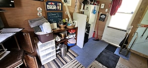 A compact kitchen with a chalkboard menu, a refrigerator, and a sink.