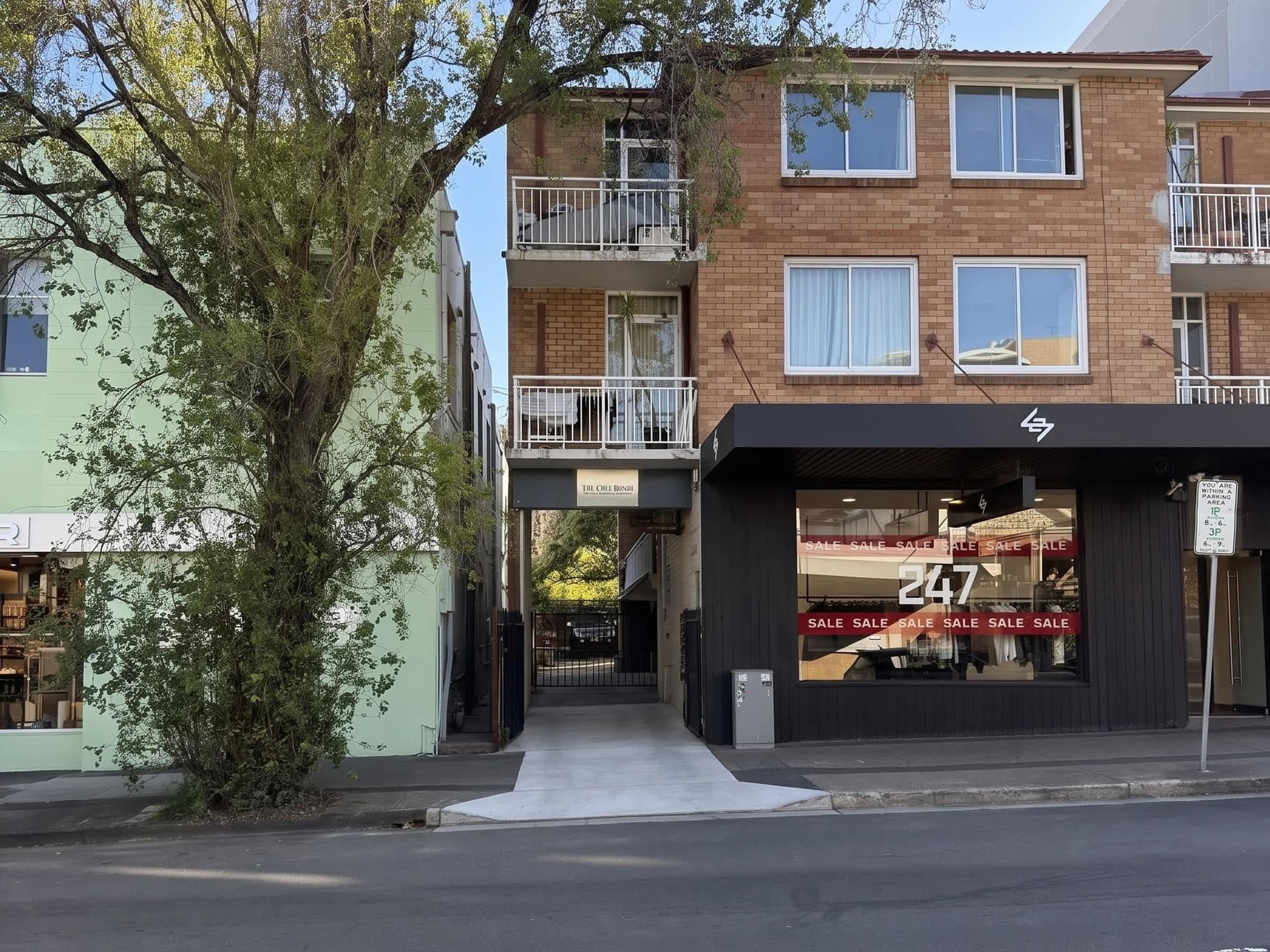 A multi-story building with a ground-level retail space and upper residential units.