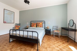 A bedroom with a bed, a chair, a desk, and a map on the wall. - A comfortable and welcoming 50 square meters apartment, perfect for four people, located on the sixth floor of a building with an elevator (NOT accessible to people with disabilities).The property is situated in a quiet area not far from the center of Tr (Trieste)