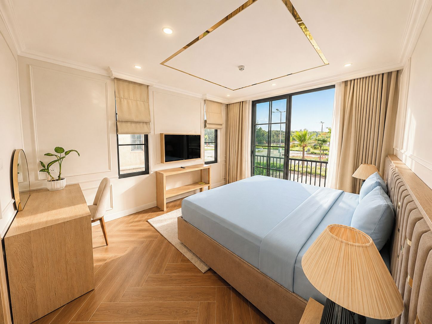 A modern hotel room with a large bed, a desk with a TV, a potted plant, and a view of a balcony.