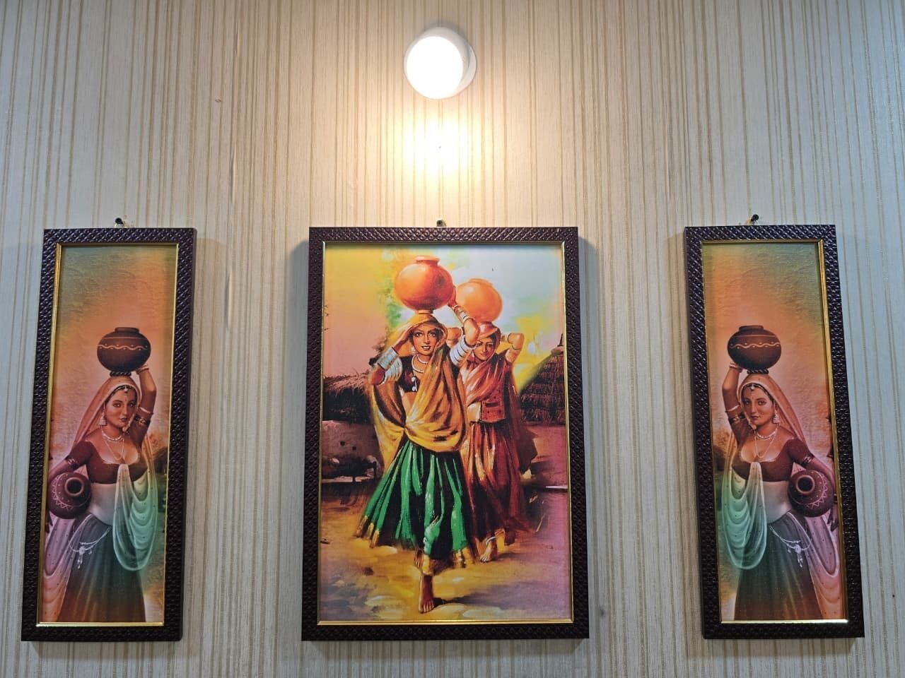 Three framed artworks on a wall.