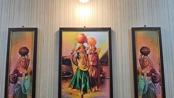 Three framed artworks on a wall.