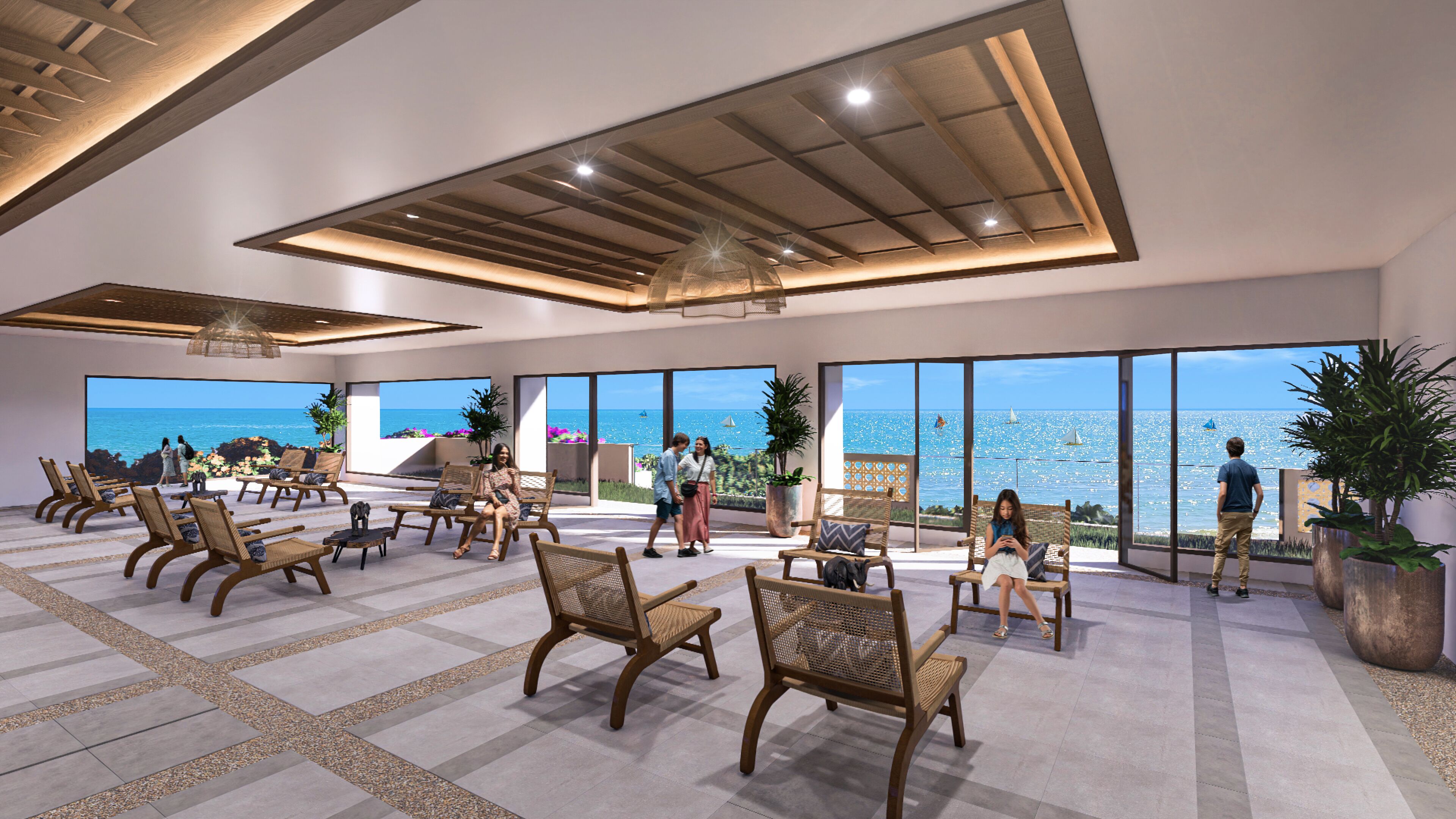 A spacious indoor area with multiple seating arrangements, large windows offering a view of the sea, and a ceiling with a unique geometric design.
