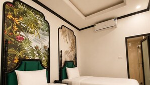 A hotel room with two beds, a mural on the wall, an air conditioning unit, and a shower area. - Hanoi Silk Crown  Boutique Hotel & Spa  (Hanoi)