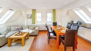A modern loft apartment with a dining area, kitchen, and living space. - To complete (Wangerooge)