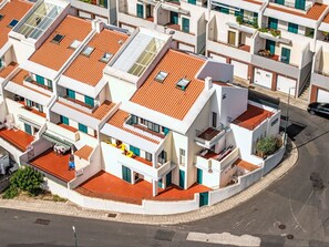 A multi-story residential building with balconies, a street view, and a clear sky. - Arrifes Porto Santo by Interhome (Porto Santo)