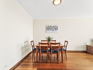A dining area with a wooden table and chairs, a potted plant, and a wall-mounted artwork. - Apartment Baly Formosa by Interhome (Funchal (Madeira))
