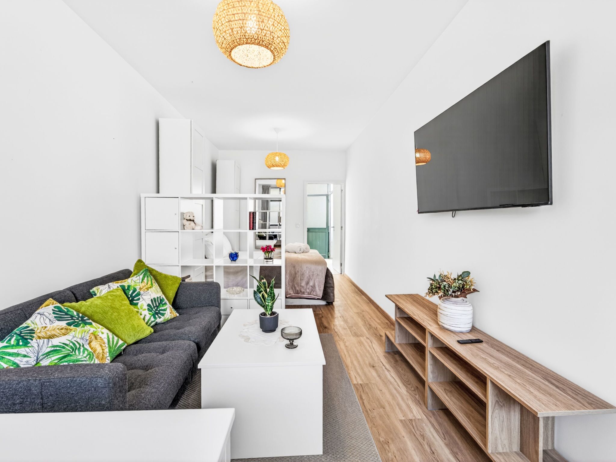 A modern living room with a sofa, coffee table, and TV.