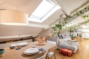 Un loft acogedor con comedor, sofá y cocina.