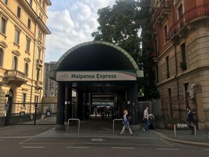 A train station entrance with a sign for Malpensa Express. - Cozy Central Tiny Studio Bright, Safe And Spotless (Milano)