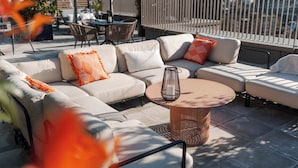 An outdoor seating area with a sofa, chairs, and a table. - Student Only YourTRIBE Southwark (London)